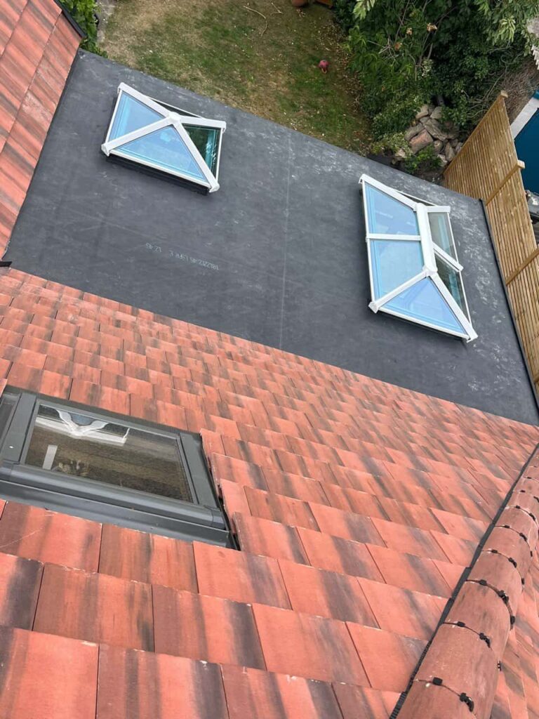 This is a photo taken from the roof ridge looking down a tiled pitched roof on to a flat roof. Works carried out by TRP Roofing Howden